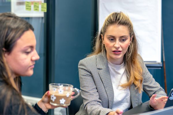 Consultants reviewing password practices and security tips on a laptop