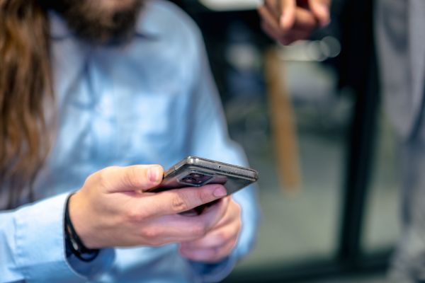 Employee reviewing identity theft protection measures on a mobile phone