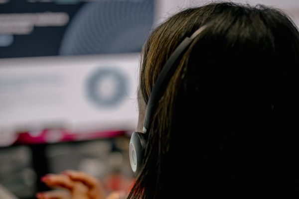 Worker analysing emails on a computer to gain insights into phishing trends for 2023