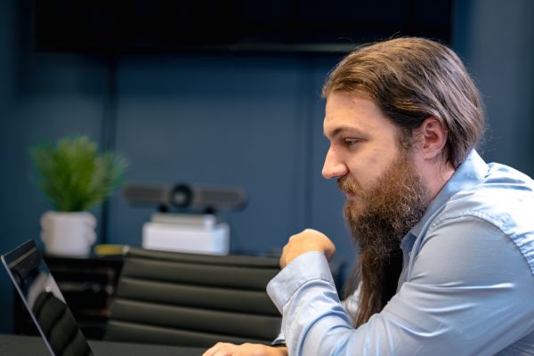 Analyst examining data related to vulnerability management trends for 2024 on a laptop