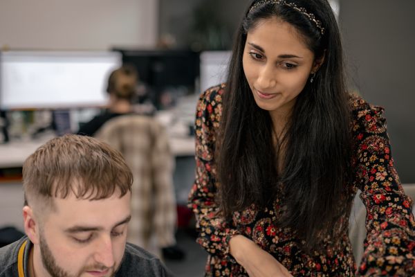 Cyber security team reviewing critical SSH vulnerability CVE-2024-6387 on laptop display