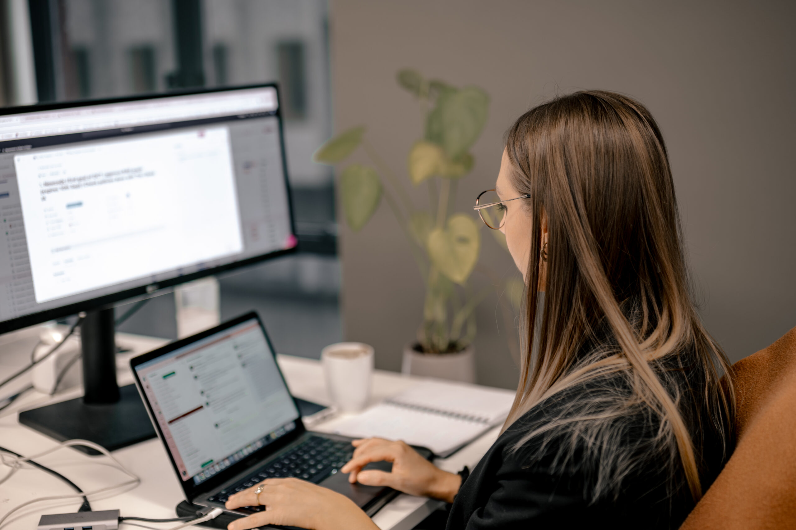 Project Manager reviewing file upload vulnerabilities on her laptop