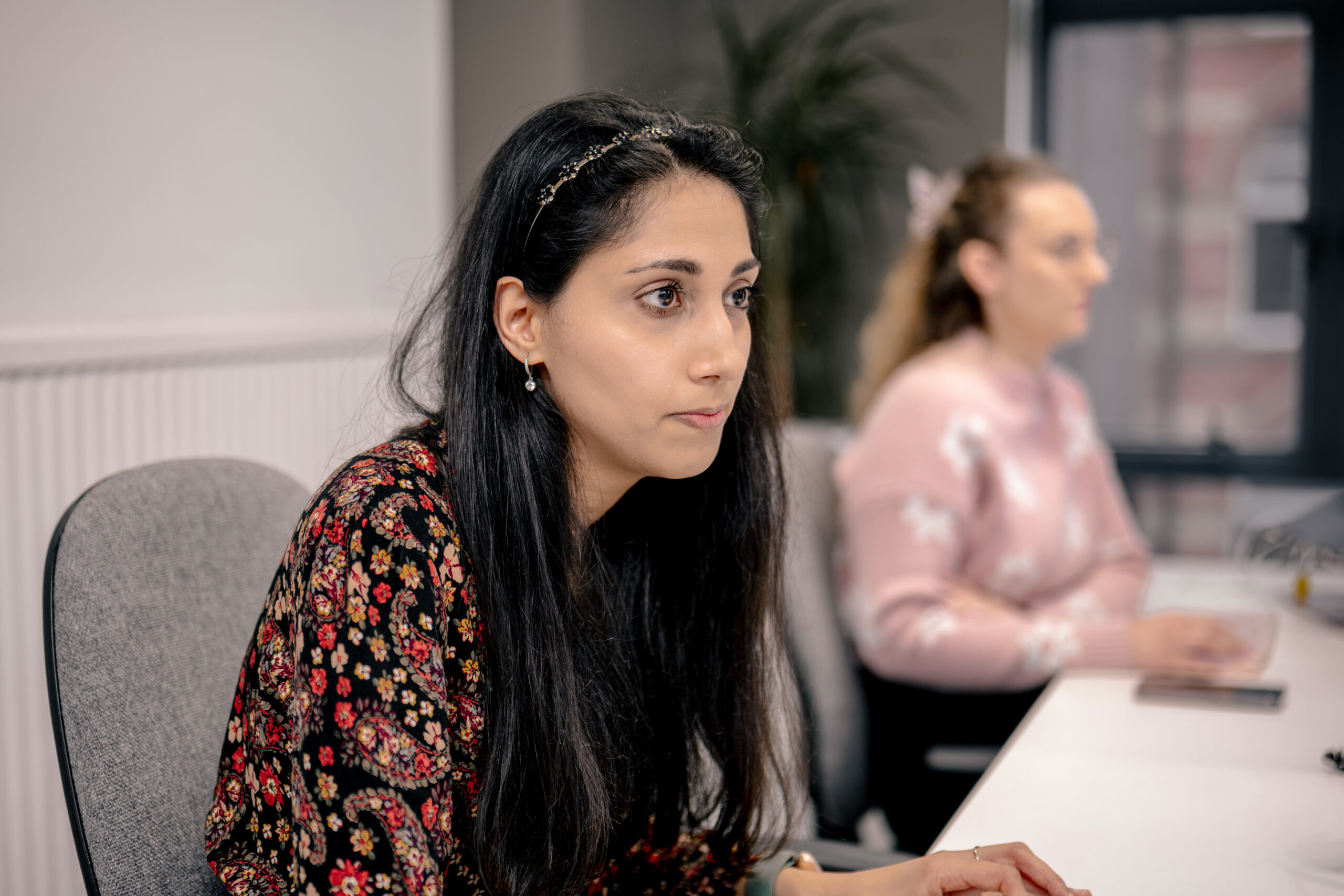 Two cyber security experts looking at a dashboard